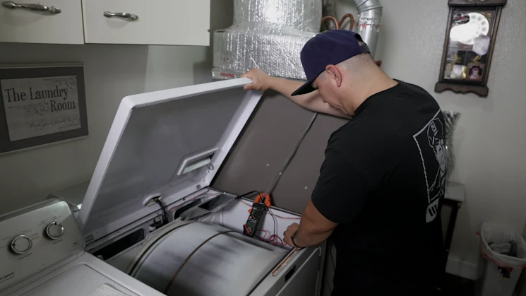 Sargents Appliance Sales and Service technician repairing a clothes dryer in Reno, Sparks and Northern Nevada
