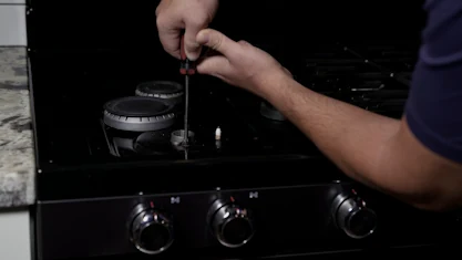 Sargents Appliance Sales and Service technician repairing a gas range in Reno, Sparks and Northern Nevada